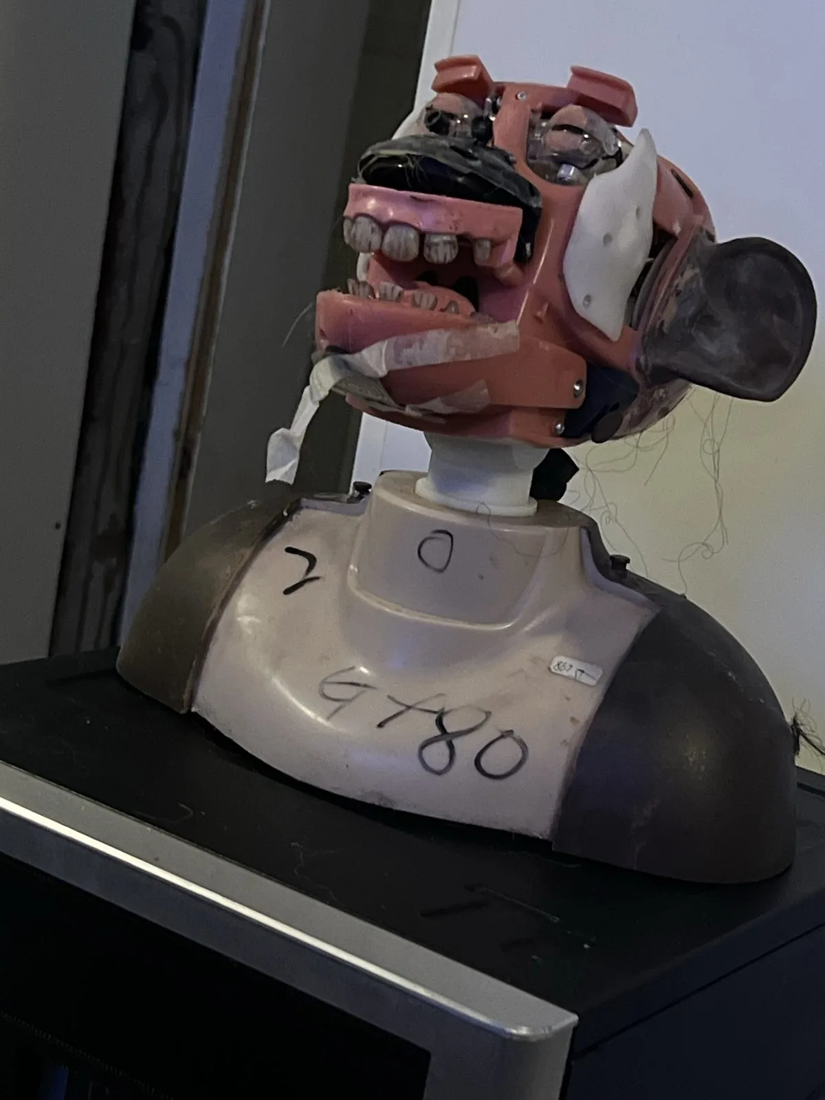 Original monkey-head assembly on a dark base