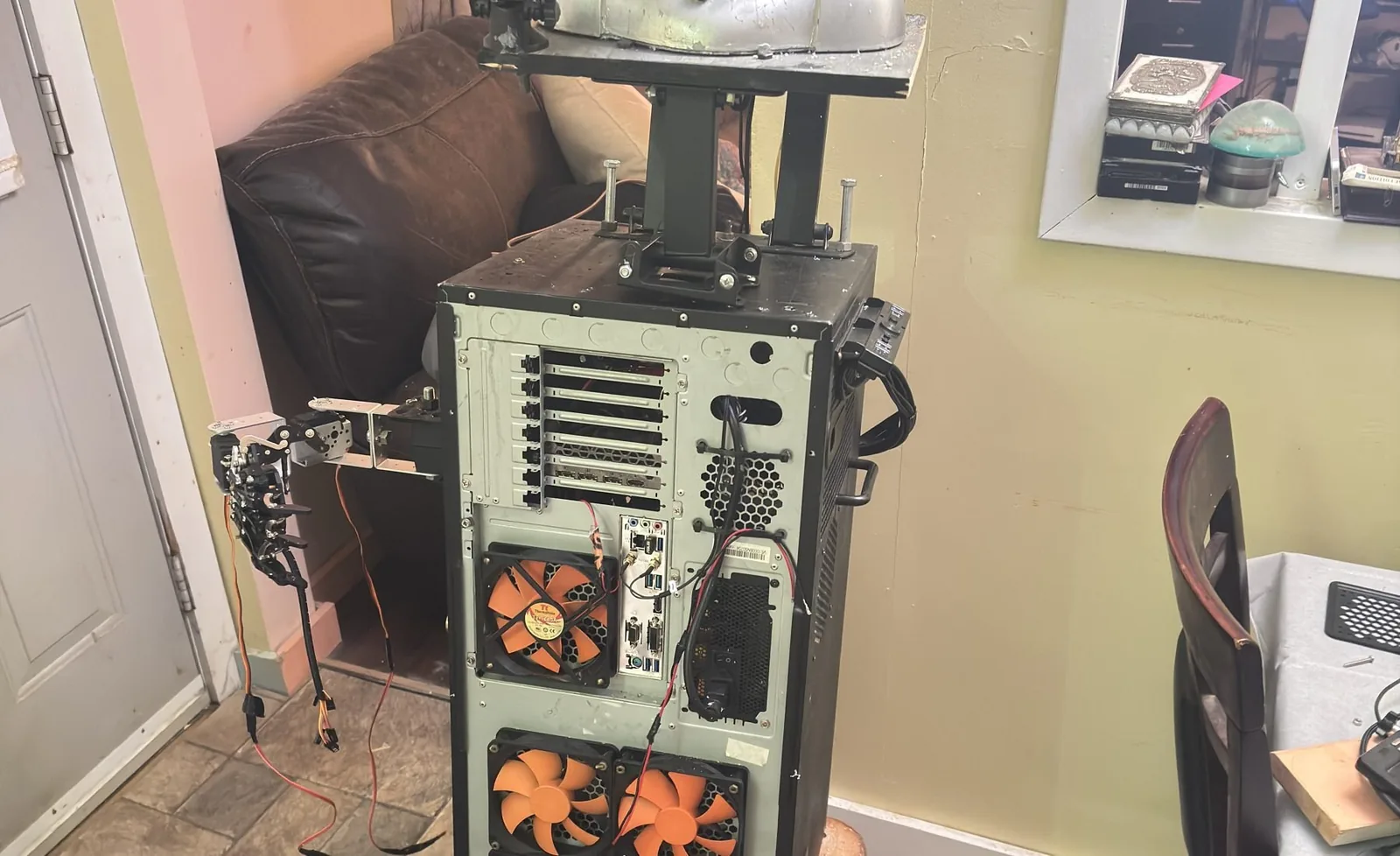 Tall experimental robotic shell with an animatronic head and illuminated controls